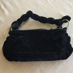 Velvet purse with braided handle.